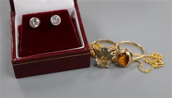 A 9ct gold citrine ring, another smoky quartz ring, a 9ct gold fine chain and a pair of 9ct gold paste-set stud earrings.